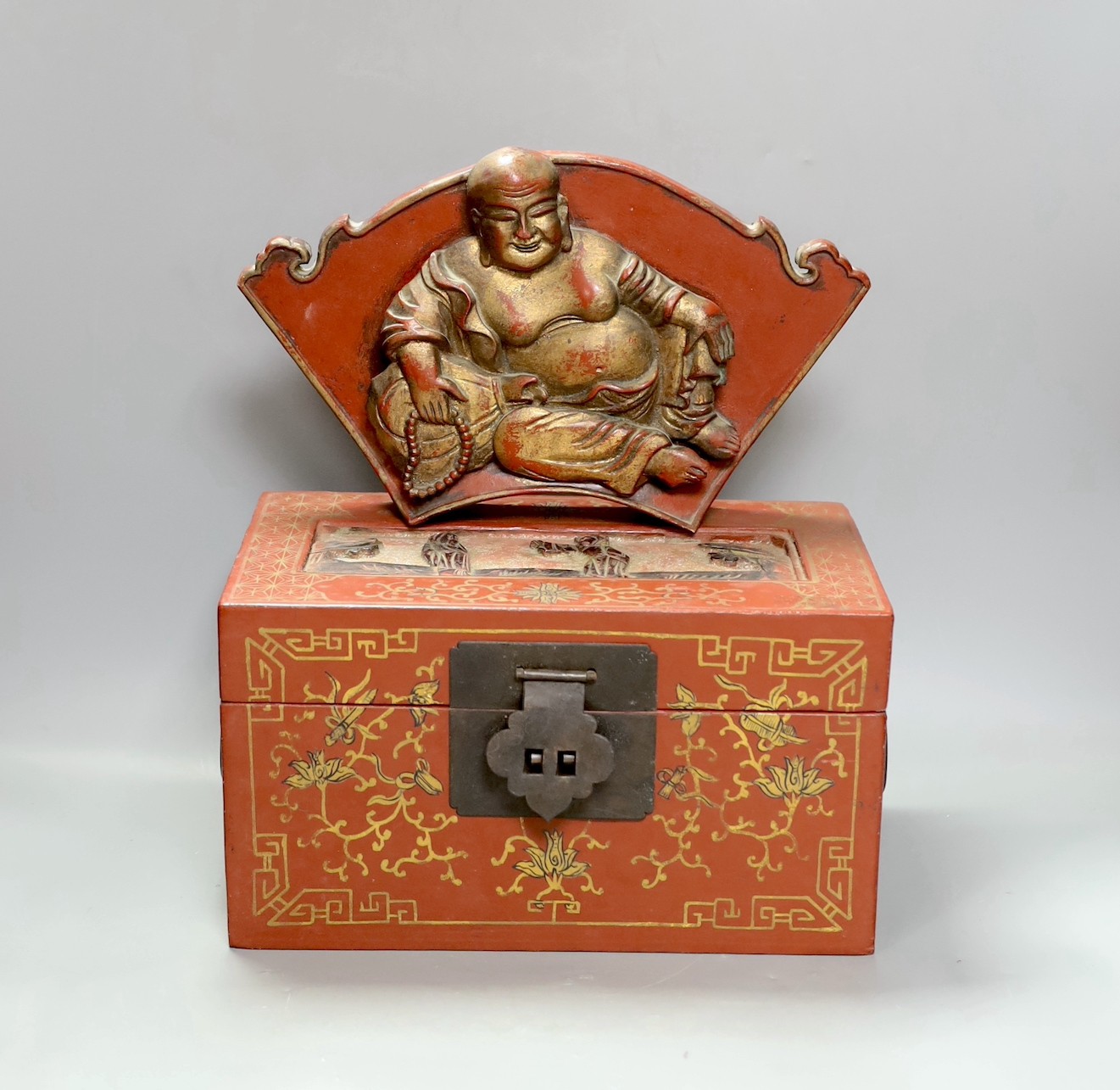 A Chinese lacquered wood Budai carving, 34cm wide, and a Chinese lacquered wood box (2)